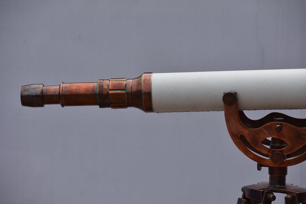 May include: A classic telescope featuring a white barrel and copper-toned metal components. The instrument is mounted on a tripod, hinting at a maritime or scientific context. The design suggests exploration and discovery, with a vintage aesthetic.
